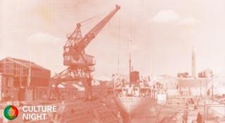 Orange halftone image of an industrial crane on a dry dock.