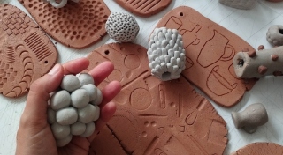 Several pieces of terracotta clay are imprinted with a variety of marks