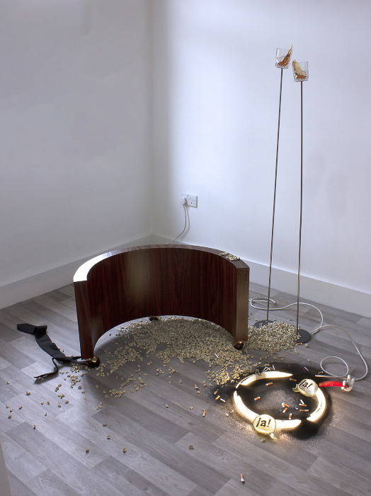 Anita Delaney

Oh! Ja,Ja!, 2019, Steel, resin, glasses, clay, paint, wood, vinyl, fluorescent light, power cord, tie, 150cm x 140cm x 175 cm approx. Courtesy the artist.