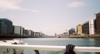 A view of the Samuel Beckett Bridge and the Dublin's skyline from The Old Liffey Ferry.